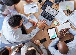 overhead photo of a group of business people working together